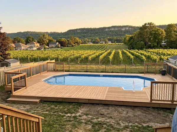 Residential pool on a Grimsby property with the Niagara Escarpment ridge visible in the background
